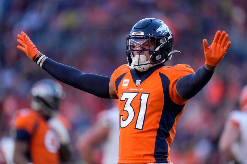 Denver Broncos safety Justin Simmons celebrates during the first half of an NFL football game against the Cleveland Browns on Sunday, Nov. 26, 2023, in Denver. (AP Photo/David Zalubowski)