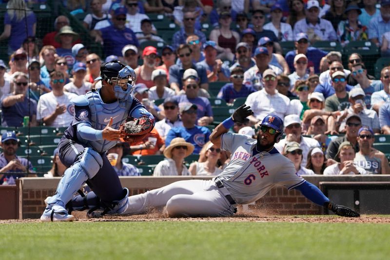 Jun 21, 2024; Chicago, Illinois, USA; New York Mets outfielder Starling Marte (6) is safe at home plate as Chicago Cubs catcher Miguel Amaya (9) makes a late tag during the fourth inning at Wrigley Field. Mandatory Credit: David Banks-USA TODAY Sports