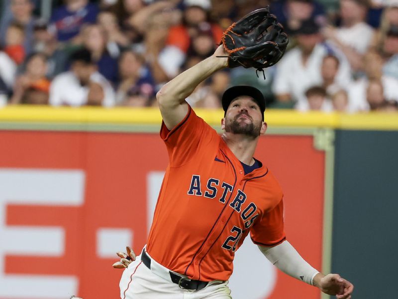 Jul 12, 2024; Houston, Texas, USA; Houston Astros left fielder Chas McCormick (20) catches a Texas Rangers flyable for an out  in the sixth inning at Minute Maid Park. Mandatory Credit: Thomas Shea-USA TODAY Sports