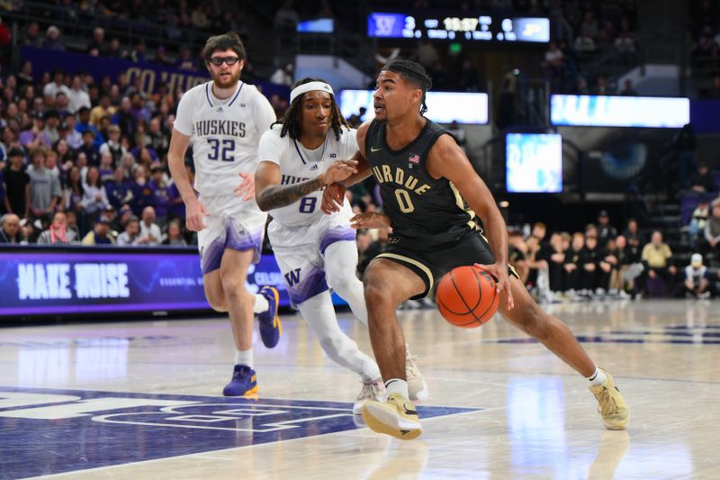 Jan 15, 2025; Seattle, Washington, USA; Purdue Boilermakers guard C.J. Cox (0) dribbles the ball towards the basket while guarded by Washington Huskies guard Tyler Harris (8) during the first half at Alaska Airlines Arena at Hec Edmundson Pavilion. Mandatory Credit: Steven Bisig-Imagn Images