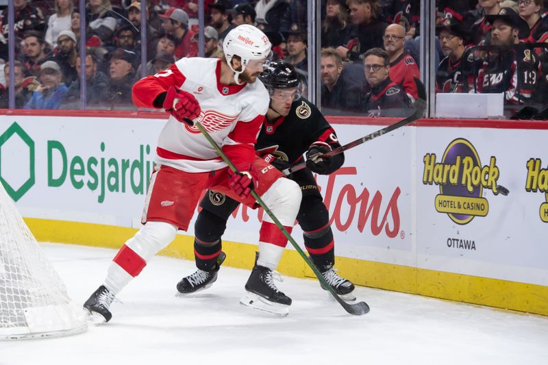 Dec 5, 2024; Ottawa, Ontario, CAN;  Detroit Red Wings center Michael Rasmussen (27) battles with Ottawa Senators center Josh Norris (9) in the second period at the Canadian Tire Centre. Mandatory Credit: Marc DesRosiers-Imagn Images