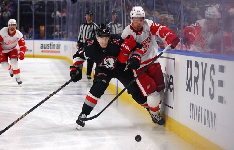 Oct 26, 2024; Buffalo, New York, USA;  Buffalo Sabres center Ryan McLeod (71) and Detroit Red Wings left wing Lucas Raymond (23) go after a loose puck during the first period at KeyBank Center. Mandatory Credit: Timothy T. Ludwig-Imagn Images