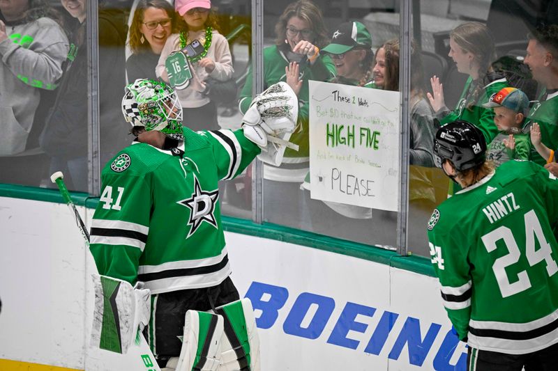 Apr 11, 2024; Dallas, Texas, USA; Dallas Stars goaltender Scott Wedgewood (41) gives a high five to a fan during warms up prior to a game against against the Winnipeg Jets at the American Airlines Center. Mandatory Credit: Jerome Miron-USA TODAY Sports