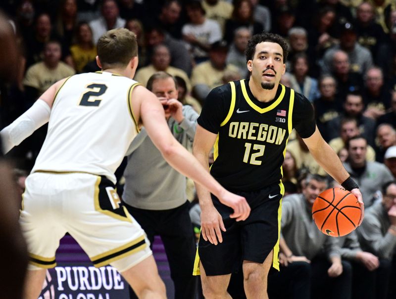 Feb 7, 2026; West Lafayette, Indiana, USA;  Oregon Ducks guard Drew Carter (12) looks to get past Purdue Boilermakers guard Fletcher Loyer (2) during the first half at Mackey Arena. Mandatory Credit: Marc Lebryk-Imagn Images