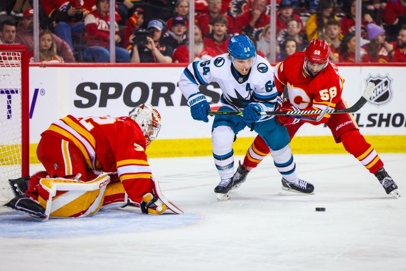 Apr 18, 2024; Calgary, Alberta, CAN; San Jose Sharks center Mikael Granlund (64) and Calgary Flames defenseman Oliver Kylington (58) battles for the puck in front of Calgary Flames goaltender Dustin Wolf (32) during the third period at Scotiabank Saddledome. Mandatory Credit: Sergei Belski-USA TODAY Sports