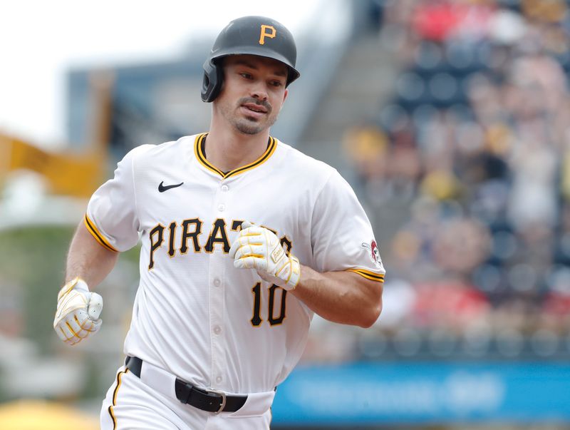 Jun 19, 2024; Pittsburgh, Pennsylvania, USA;  Pittsburgh Pirates left fielder Bryan Reynolds (10) circles the bases on a solo home run against the Cincinnati Reds during the eighth inning at PNC Park. The Pirates shutout the Reds 1-0. Mandatory Credit: Charles LeClaire-USA TODAY Sports