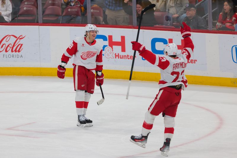 Jan 16, 2025; Sunrise, Florida, USA; Detroit Red Wings right wing Patrick Kane (88) celebrates with left wing Lucas Raymond (23) after scoring against the Florida Panthers during the second period at Amerant Bank Arena. Mandatory Credit: Sam Navarro-Imagn Images