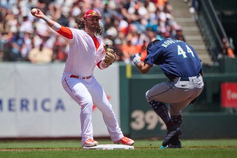 Jul 4, 2023; San Francisco, California, USA; Seattle Mariners outfielder Teoscar Hernandez (35) turns a double play against Seattle Mariners outfielder Julio Rodriguez (44) during the first inning at Oracle Park. Mandatory Credit: Robert Edwards-USA TODAY Sports