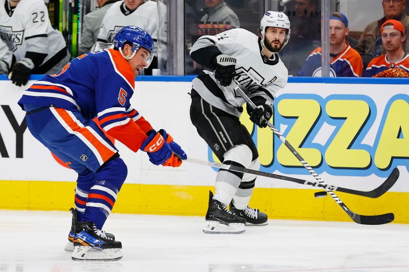 Apr 22, 2024; Edmonton, Alberta, CAN; Los Angeles Kings forward Phillip Danault (24) makes a pass over the stick of Edmonton Oilers defensemen Cody Ceci (5) during the second period in game one of the first round of the 2024 Stanley Cup Playoffs at Rogers Place. Mandatory Credit: Perry Nelson-USA TODAY Sports