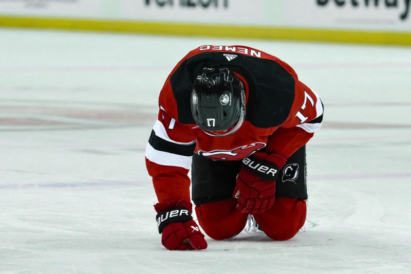 Feb 22, 2024; Newark, New Jersey, USA; New Jersey Devils defenseman Simon Nemec (17) reacts after an injury during the second period against the New York Rangers at Prudential Center. Mandatory Credit: John Jones-USA TODAY Sports