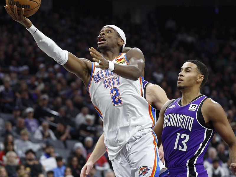 SACRAMENTO, CALIFORNIA - NOVEMBER 25: Shai Gilgeous-Alexander #2 of the Oklahoma City Thunder goes for a layup over Keegan Murray #13 of the Sacramento Kings during the second quarter at Golden 1 Center on November 25, 2024 in Sacramento, California. NOTE TO USER: User expressly acknowledges and agrees that, by downloading and or using this photograph, User is consenting to the terms and conditions of the Getty Images License Agreement. (Photo by Thearon W. Henderson/Getty Images)