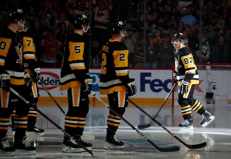 Oct 10, 2023; Pittsburgh, Pennsylvania, USA; Pittsburgh Penguins center Sidney Crosby (87) takes the ice as teammates look on during player introductions against the Chicago Blackhawks at the PPG Paints Arena. Mandatory Credit: Charles LeClaire-USA TODAY Sports