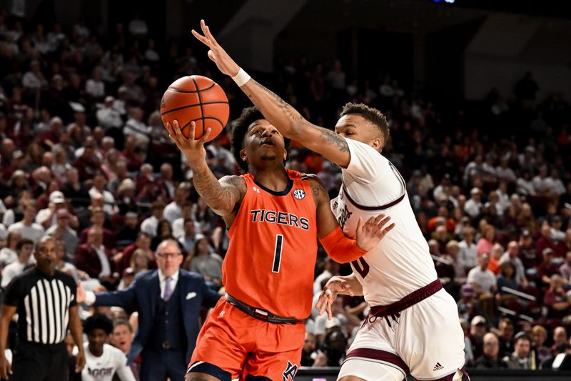 Feb 7, 2023; College Station, Texas, USA;  Auburn Tigers guard Wendell Green Jr. (1) goes for a layup as Texas A&M Aggies guard Dexter Dennis (0) defends during the first half at Reed Arena. Mandatory Credit: Maria Lysaker-USA TODAY Sports