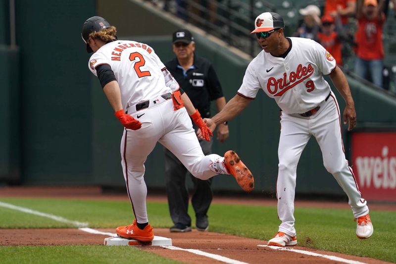 Apr 17, 2024; Baltimore, Maryland, USA; Baltimore Orioles shortstop Gunnar Henderson (2) greeted by coach Anthony Sanders (9) following his solo home run in the first inning  against the Minnesota Twins at Oriole Park at Camden Yards. Mandatory Credit: Mitch Stringer-USA TODAY Sports