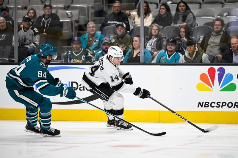 Oct 29, 2024; San Jose, California, USA; Los Angeles Kings right wing Alex Laferriere (14) skates with the puck against San Jose Sharks defenseman Jan Rutta (84) in the first period at SAP Center at San Jose. Mandatory Credit: Eakin Howard-Imagn Images