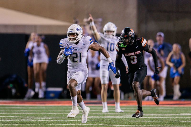 Sep 19, 2025; Stillwater, Oklahoma, USA; Tulsa Golden Hurricane running back Dominic Richardson (21) runs the ball past Oklahoma State Cowboys cornerback Cam Smith (3) during the second half at Boone Pickens Stadium. Mandatory Credit: William Purnell-Imagn Images