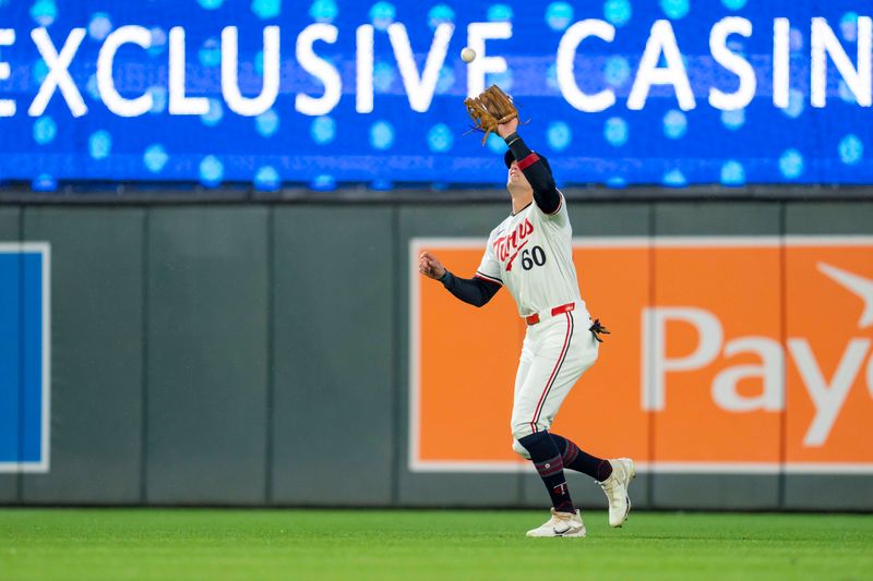 May 19, 2025; Minneapolis, Minnesota, USA; Minnesota Twins right fielder Carson McCusker (60) catches a fly ball against the Cleveland Guardians in the third inning at Target Field. Mandatory Credit: Jesse Johnson-Imagn Images