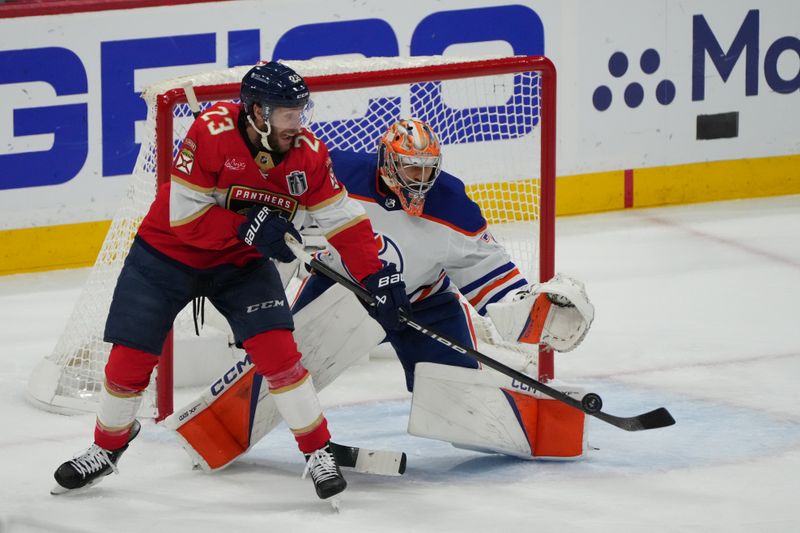 Jun 24, 2024; Sunrise, Florida, USA; Florida Panthers forward Carter Verhaeghe (23) tips in the puck to score against Edmonton Oilers goaltender Skinner Stuart (74) during the first period in game seven of the 2024 Stanley Cup Final at Amerant Bank Arena. Mandatory Credit: Jim Rassol-USA TODAY Sports