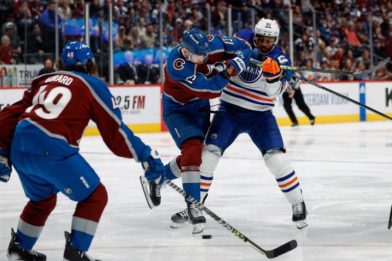 Apr 11, 2023; Denver, Colorado, USA; Colorado Avalanche right wing Valeri Nichushkin (13) and Edmonton Oilers left wing Evander Kane (91) battle for the puck as defenseman Samuel Girard (49) defends in the first period at Ball Arena. Mandatory Credit: Isaiah J. Downing-USA TODAY Sports