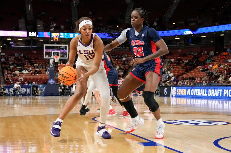 Mar 9, 2024; Greensville, SC, USA; LSU Lady Tigers forward Angel Reese (10) handles the ball against Ole Miss Rebels center Rita Igbokwe (32) during the second half at Bon Secours Wellness Arena. Mandatory Credit: Jim Dedmon-USA TODAY Sports