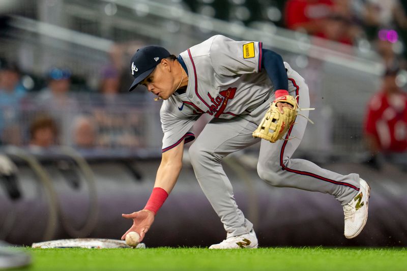 Aug 26, 2024; Minneapolis, Minnesota, USA; Atlanta Braves third baseman Gio Urshela (9) attempts to field a ground ball with his hand against the Minnesota Twins in the fifth inning at Target Field. Mandatory Credit: Jesse Johnson-USA TODAY Sports