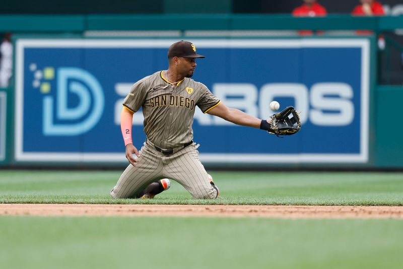 Jul 25, 2024; Washington, District of Columbia, USA; San Diego Padres second baseman Xander Bogaerts (2) bobbles the ball while making a play to first base on a ground ball by Washington Nationals catcher Keibert Ruiz (not pictured) during the eighth inning at Nationals Park. Mandatory Credit: Geoff Burke-USA TODAY Sports
