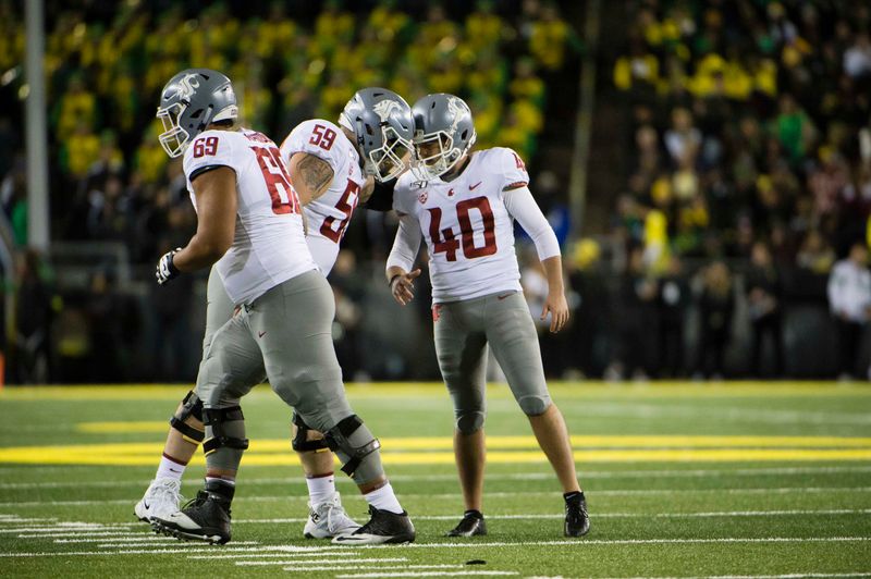 Oct 26, 2019; Eugene, OR, USA; Washington State Cougars offensive lineman Brian Greene (59) celebrates with place kicker Blake Mazza (40) after scoring a field goal during the first half at Autzen Stadium. Mandatory Credit: Troy Wayrynen-USA TODAY Sports