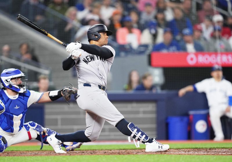 Apr 17, 2024; Toronto, Ontario, CAN; New York Yankees right fielder Juan Soto (22) hits an RBI double against the Toronto Blue Jays during the fifth inning at Rogers Centre. Mandatory Credit: Nick Turchiaro-USA TODAY Sports