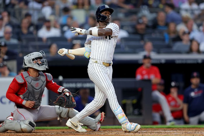 Jun 6, 2025; Bronx, New York, USA; New York Yankees third baseman Jazz Chisholm Jr. (13) follows through on an RBI single against the Boston Red Sox during the second inning at Yankee Stadium. Mandatory Credit: Brad Penner-Imagn Images