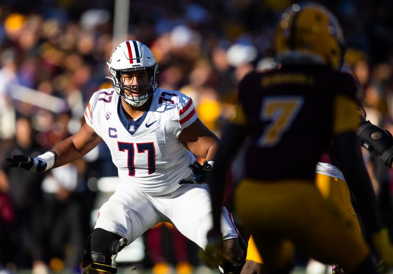 Nov 25, 2023; Tempe, Arizona, USA; Arizona Wildcats offensive lineman Jordan Morgan (77) against the Arizona State Sun Devils during the Territorial Cup at Mountain America Stadium. Mandatory Credit: Mark J. Rebilas-USA TODAY Sports