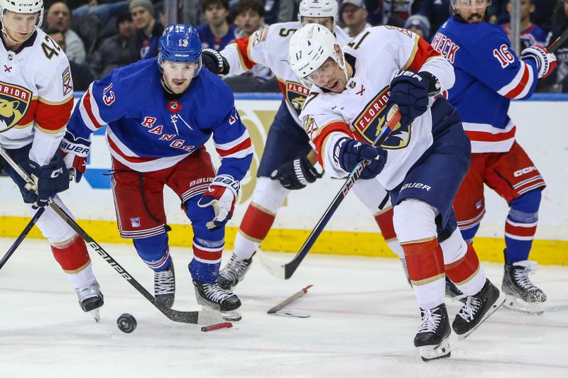 Mar 4, 2024; New York, New York, USA;  Florida Panthers center Evan Rodrigues (17) clears the puck in the third period against the New York Rangers at Madison Square Garden. Mandatory Credit: Wendell Cruz-USA TODAY Sports