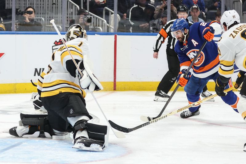 Nov 26, 2025; Elmont, New York, USA; Boston Bruins goaltender Jeremy Swayman (1) defends against a shot on goal attempt from New York Islanders center Kyle Palmieri (21) in the second period at UBS Arena. Mandatory Credit: Wendell Cruz-Imagn Images
