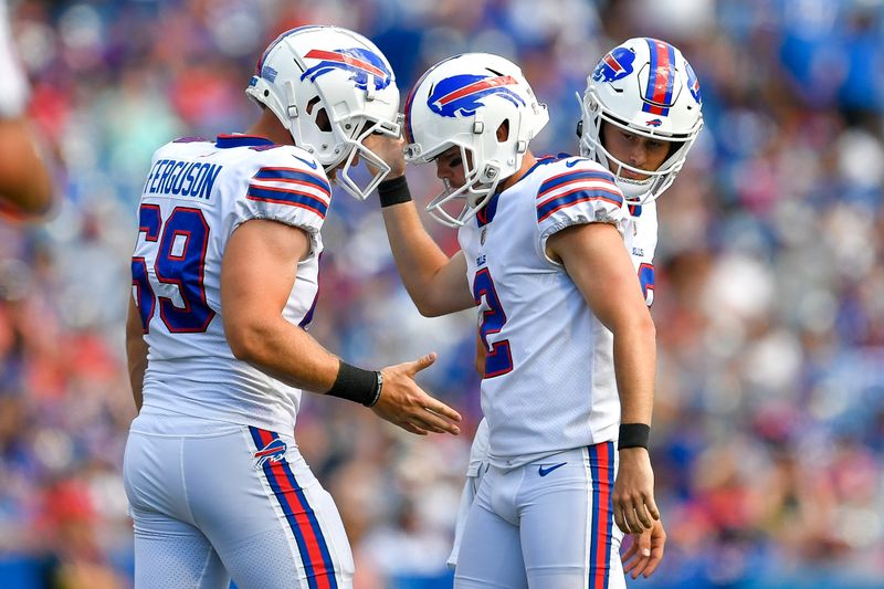 Buffalo Bills kicker Tyler Bass, center, celebrates with long snapper Reid Ferguson after kicking an extra point against the Denver Broncos during the first half of a preseason NFL football game in Orchard Park, N.Y., Saturday, Aug. 20, 2022. (AP Photo/Adrian Kraus)