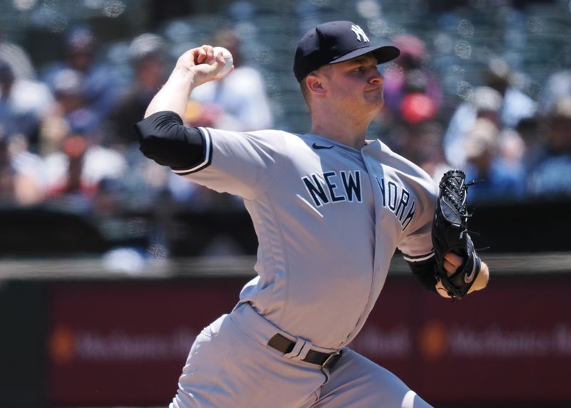 Jun 29, 2023; Oakland, California, USA; New York Yankees starting pitcher Clarke Schmidt (36) pitches the ball against the Oakland Athletics during the first inning at Oakland-Alameda County Coliseum. Mandatory Credit: Kelley L Cox-USA TODAY Sports