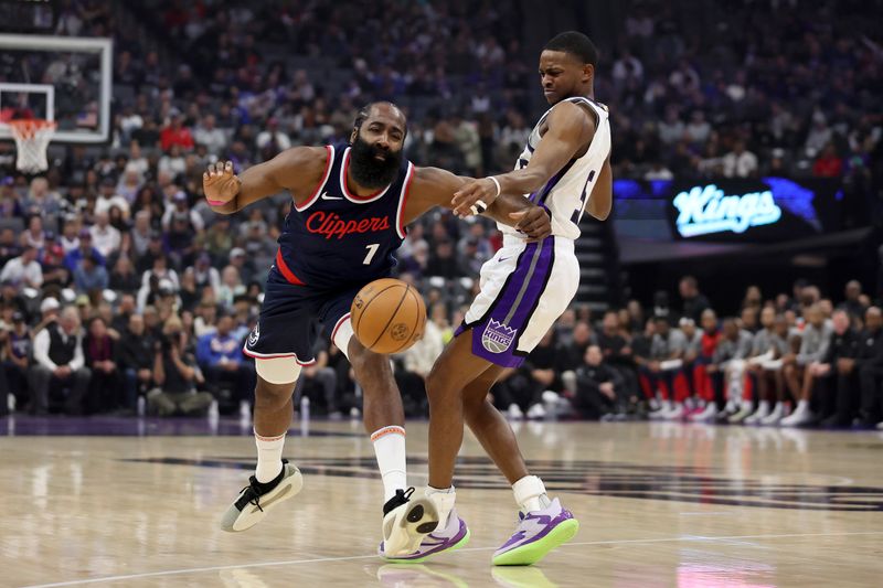 SACRAMENTO, CALIFORNIA - NOVEMBER 08: James Harden #1 of the LA Clippers is fouled by De'Aaron Fox #5 of the Sacramento Kings in the first half at Golden 1 Center on November 08, 2024 in Sacramento, California. NOTE TO USER: User expressly acknowledges and agrees that, by downloading and/or using this photograph, user is consenting to the terms and conditions of the Getty Images License Agreement.  (Photo by Ezra Shaw/Getty Images)