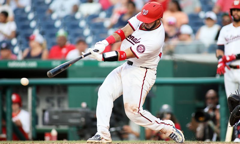 Jul 6, 2024; Washington, District of Columbia, USA; Washington Nationals catcher Keibert Ruiz (20) hits a double during the eighth inning against the St. Louis Cardinals at Nationals Park. Mandatory Credit: Daniel Kucin Jr.-USA TODAY Sports