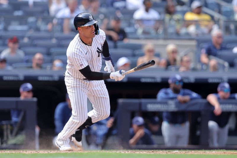 Jul 20, 2024; Bronx, New York, USA; New York Yankees catcher Carlos Narvaez (94) follows through on a single against the Tampa Bay Rays in his first MLB at bat during the ninth inning at Yankee Stadium. Mandatory Credit: Brad Penner-USA TODAY Sports