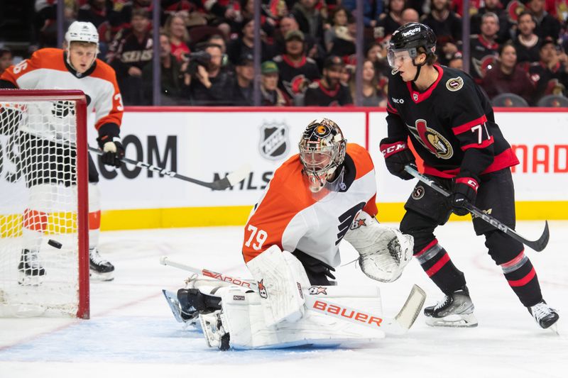 Oct 14, 2023; Ottawa, Ontario, CAN; Philadelphia Flyers goalie Carter Hart (79) is unable to stop the puck on a goal by the Ottawa Senators as center Ridley Greig (71) looks on in the first period at the Canadian Tire Centre. Mandatory Credit: Marc DesRosiers-USA TODAY Sports