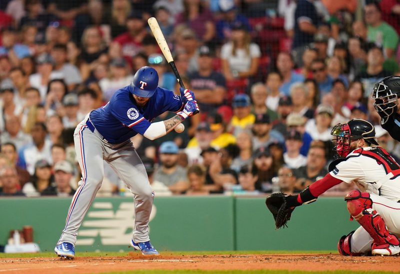 Aug 12, 2024; Boston, Massachusetts, USA; Texas Rangers catcher Jonah Heim (28) is hit by a pitch against the Boston Red Sox in the third inning at Fenway Park. Mandatory Credit: David Butler II-USA TODAY Sports