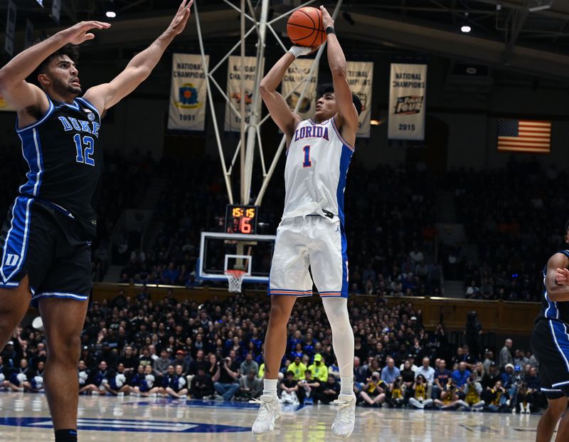 Dec 2, 2025; Durham, North Carolina, USA; Florida Gators guard Xaivian Lee (1) shoots over Duke Blue Devils forward Cameron Boozer (12) during the first half at Cameron Indoor Stadium. Mandatory Credit: Rob Kinnan-Imagn Images