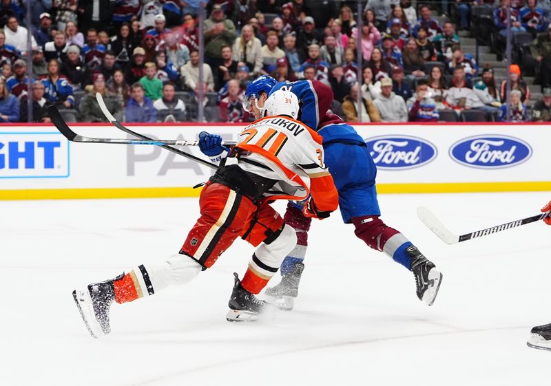 Oct 18, 2024; Denver, Colorado, USA; Colorado Avalanche center Nathan MacKinnon (29) shoots and scores in overtime past Anaheim Ducks defenseman Pavel Mintyukov (34) at Ball Arena. Mandatory Credit: Ron Chenoy-Imagn Images