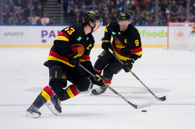 Jan 27, 2024; Vancouver, British Columbia, CAN; Vancouver Canucks forward J.T. Miller (9) watches defenseman Quinn Hughes (43) handles the puck against the Columbus Blue Jackets in overtime at Rogers Arena. Canucks won 5-4 in overtime. Mandatory Credit: Bob Frid-USA TODAY Sports