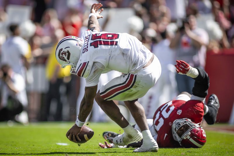 Oct 12, 2024; Tuscaloosa, Alabama, USA; Alabama Crimson Tide defensive lineman LT Overton (22) knocks South Carolina Gamecocks quarterback LaNorris Sellers (16) off balance as he carries the ball down the field during the second quarter at Bryant-Denny Stadium. Mandatory Credit: Will McLelland-Imagn Images