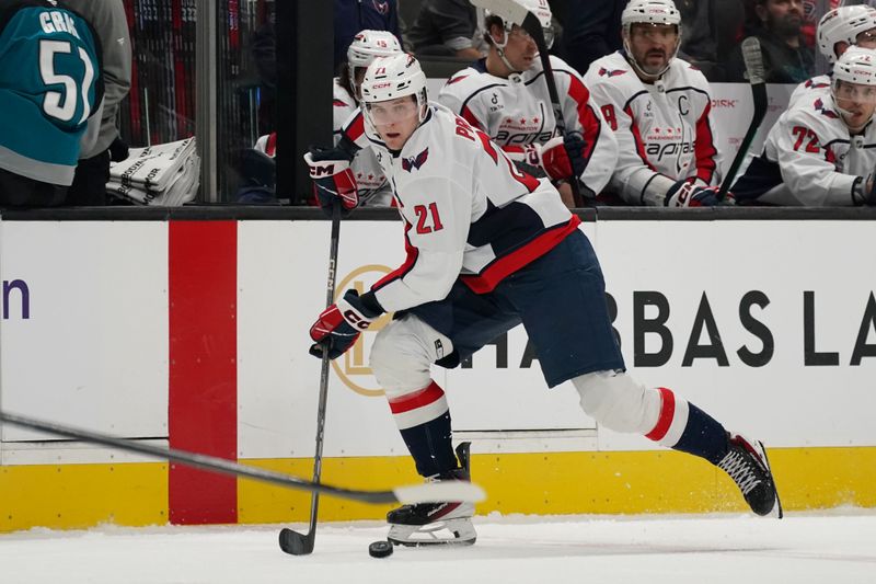 Dec 3, 2025; San Jose, California, USA; Washington Capitals center Aliaksei Protas (21) controls the puck against the San Jose Sharks in the third period at SAP Center at San Jose. Mandatory Credit: David Gonzales-Imagn Images
