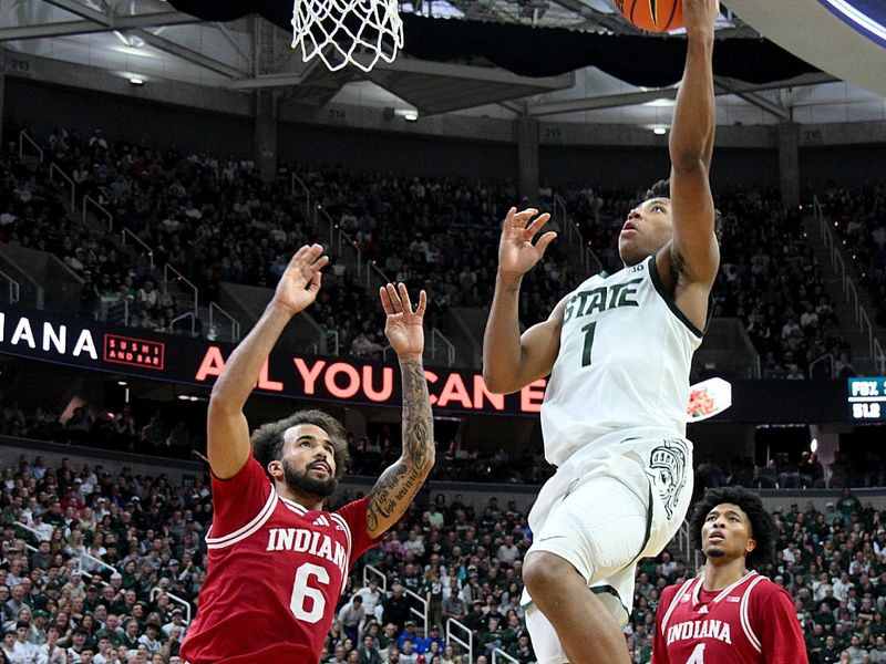 Jan 13, 2026; East Lansing, Michigan, USA;  Michigan State Spartans guard Jeremy Fears Jr. (1) gets a steal and fast break past Indiana Hoosiers guard Tayton Conerway (6) during the second half at Jack Breslin Student Events Center. Mandatory Credit: Dale Young-Imagn Images