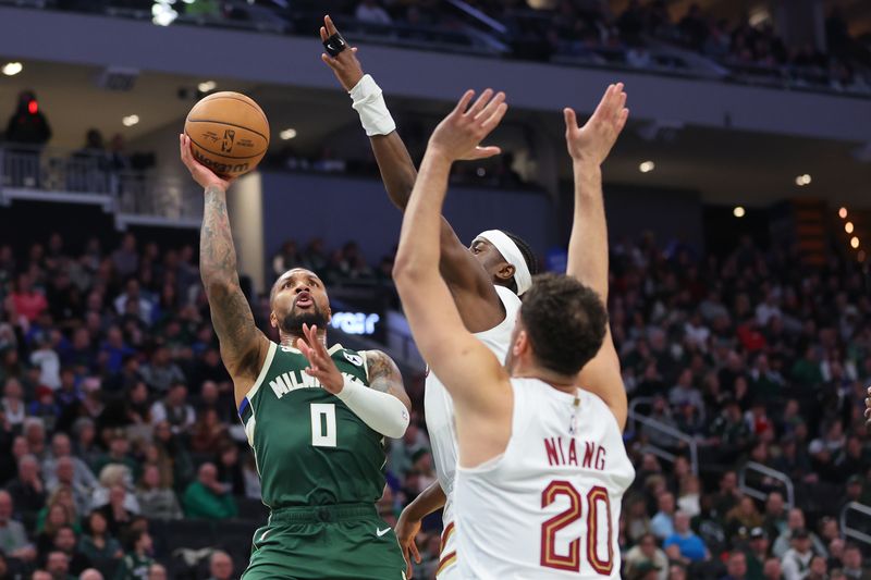 MILWAUKEE, WISCONSIN - JANUARY 24: Damian Lillard #0 of the Milwaukee Bucks is defended by Caris LeVert #3 of the Cleveland Cavaliers during a game at Fiserv Forum on January 24, 2024 in Milwaukee, Wisconsin. NOTE TO USER: User expressly acknowledges and agrees that, by downloading and or using this photograph, User is consenting to the terms and conditions of the Getty Images License Agreement. (Photo by Stacy Revere/Getty Images)