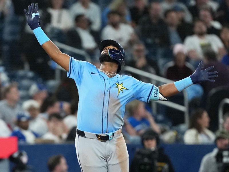 May 13, 2025; Toronto, Ontario, CAN; Tampa Bay Rays third baseman Junior Caminero (13) celebrates hitting a grand slam home run against the Toronto Blue Jays during the ninth inning at Rogers Centre. Mandatory Credit: Nick Turchiaro-Imagn Images