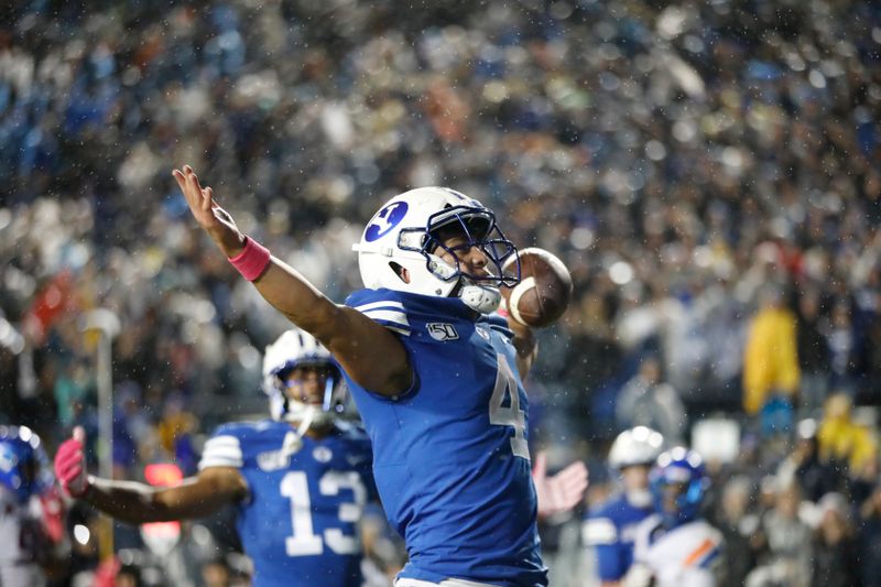 Oct 19, 2019; Provo, UT, USA; BYU Cougars running back Lopini Katoa (4) celebrates with wide receiver Micah Simon (13) after a touchdown against the Boise State Broncos  in the first quarter at LaVell Edwards Stadium. Mandatory Credit: Gabe Mayberry-USA TODAY Sports