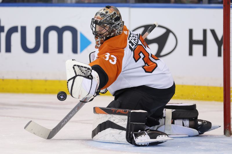 Mar 26, 2024; New York, New York, USA; Philadelphia Flyers goaltender Samuel Ersson (33) makes a save against the New York Rangers during the first period at Madison Square Garden. Mandatory Credit: Brad Penner-USA TODAY Sports