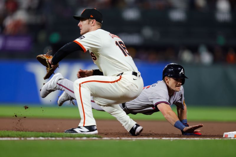 Aug 12, 2024; San Francisco, California, USA; Atlanta Braves outfielder Luke Williams (65) dives back to first base during the eighth inning against the San Francisco Giants at Oracle Park. Mandatory Credit: Sergio Estrada-USA TODAY Sports